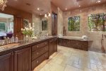 En suite Master bath includes walk-in shower with floor to ceiling stone, spa bathtub, oversized double sink vanity